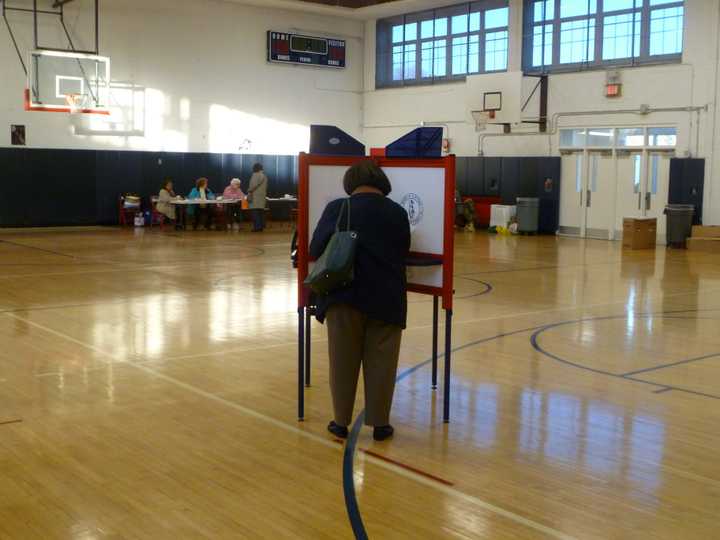 A resident of District 25 in Eastchester casts her vote at  Eastchester High School.