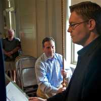 <p>Historical Society President Erik Anderson reads off the  13 original colonies, as state Sen. Bob Duff tolls the tower bell 13 times.</p>