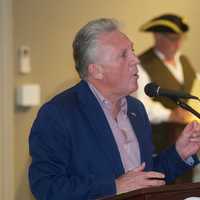 <p>Norwalk Mayor Harry Rilling welcomes the crowd to the patriotic ceremony. </p>