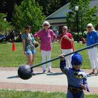 <p>Batman lifts a barbell with ease.</p>