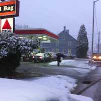 <p>A pedestrian protects herself from the snow with an umbrella on Danbury&#x27;s Main Street late Wednesday afternoon.</p>