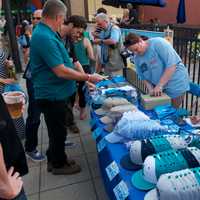 <p>Hats are a popular seller at the block party.</p>