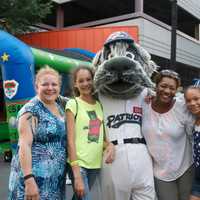 <p>Fans pose with one of the mascots at Tuesday&#x27;s block party.</p>