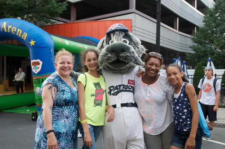 Fans pose with one of the mascots at Tuesday&#x27;s block party.