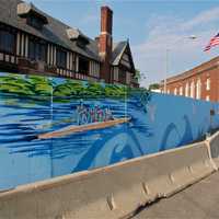 <p>A painting of rowers on the Saugatuck River brighten the construction site fence in downtown Westport. </p>