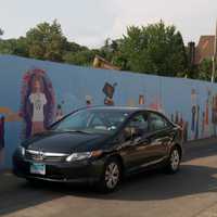 <p>A car heads past the wall. </p>