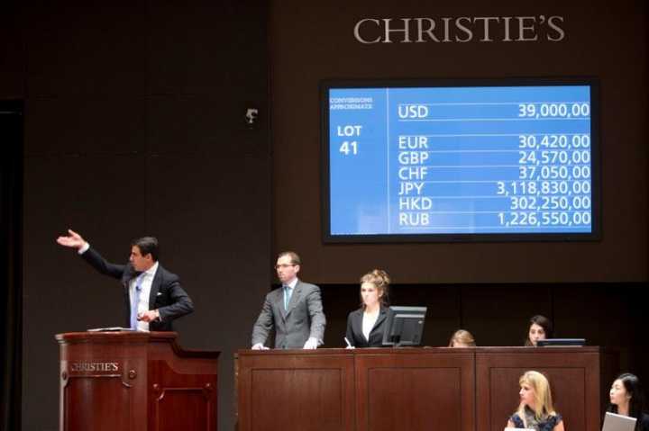 Christies auctioneer Andreas Rumbler hammers down Claude Monets Nymphéas,&quot; 
which achieved the second highest price for the artist at $43.8 million.