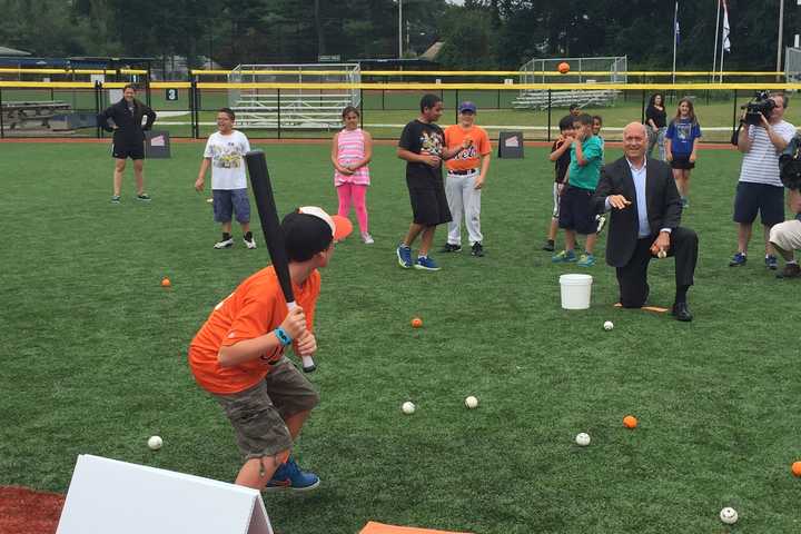 Baseball Hall of Famer Cal Ripken, Jr. plays Quickball with kids on a new field in Bridgeport built by the Cal Ripken, Sr. Foundation.