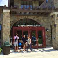 <p>Campers and parents enter the Westport Weston Family YMCA on Friday.</p>