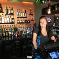 <p>Flipside Burgers and Bar Manager Lindsay Oakes poses behind the bar.</p>