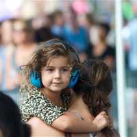 <p>A young girl wears headphones to protect her ears at Thursday&#x27;s concert.</p>