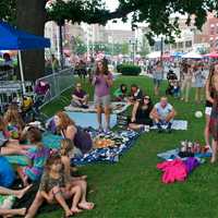 <p>Music lovers, families and children lounge on the grounds at Columbus Park, listening to the opening act at Thursday&#x27;s concert.</p>