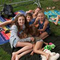 <p>Music lovers, families and children lounge on the grounds at Columbus Park listening to the opening act at Thursday&#x27;s concert.</p>