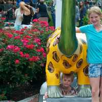 <p>Children enjoy the dinosaurs in the park area.</p>