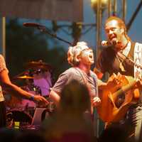 <p>A fan gets to sing on stage with Michael Franti.</p>