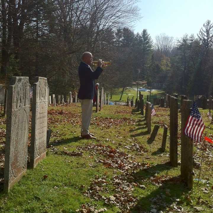 Tom Gossett plays taps during ceremony at South Salem Presbyterian Church honoring Colonial-era veterans.