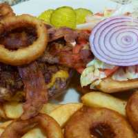 <p>The South Side BBQ Pulled Pork Burger comes with cheese, pulled pork, bacon, fries and onion rings.</p>