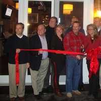 <p>Jimmy Love cuts the ribbon on Jimmy&#x27;s Southside Tavern with members of the Darien Chamber of Commerce.</p>