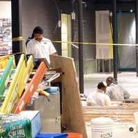 <p>A restoration crew works inside the Nike store on Westport&#x27;s Main Street on Wednesday evening. </p>