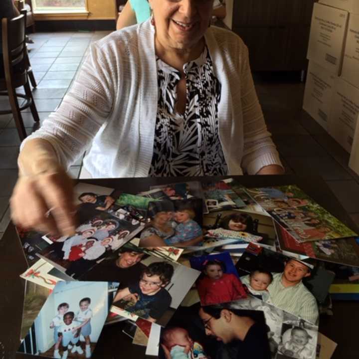 Beth Cohen with photos of her clients over the years.