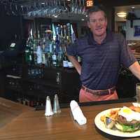 <p>Bogey&#x27;s Grille &amp; Tap Room Co-Owner Jim Stablein with a Prime Beef Burger.</p>