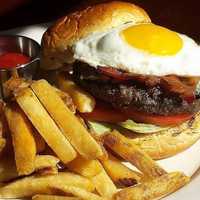 <p>The Prime Beef Burger, featuring Allen Brothers USDA prime blend, applewood smoked bacon, blue cheese and a fried egg.</p>