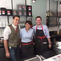 <p>NEAT staff Trevor Rosetta, Sandra Walimaki and Nathan Francis pose for a picture at the bar Thursday.</p>