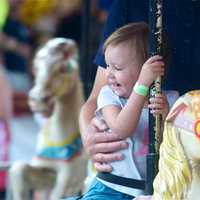 <p>A girl rides the carousel at the MVFD carnival.</p>