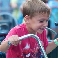 <p>A boy enjoys the big bikes at the MVFD carnival.</p>