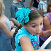 <p>Two girls watch the action at the carnival.</p>