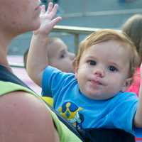 <p>A young child enjoys the excitement of the carnival.</p>