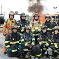 <p>New career firefighters in their gear. Kneeling from right to left: Heriberto Virella, William Simons, Thomas Leonard and Cea Fong. Back Row: Christopher Duffelmeyer, Christopher Rimm, Michael Mackenzie, John Giordano Jr. and , Hassan Washington.</p>