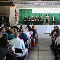 <p>Westchester County Executive Rob Astorino congratulates 60 new volunteer firefighters Thursday evening during their graduation in Valhalla. About 250 family members and friends attended the ceremony at the Department of Emergency Services.</p>