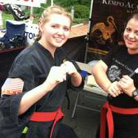 <p>Senseis Shannon Davis, left, and Erika Grieco strike a pose, at the Kempo Academy of Martial Arts tent at the Wilton sidewalk sale event Saturday.</p>