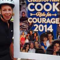 <p>Alexis Harrison, a rider for Team SHU, stands by a poster prior to last year&#x27;s ride.</p>