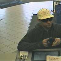 <p>The suspect presenting a note presumably demanding cash during Saturday&#x27;s Scarsdale bank robbery.</p>