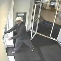 <p>The suspect leaving Webster Bank in Scarsdale on Saturday.</p>