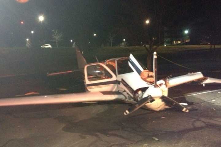 A small plane that crash-landed early Saturday sits in a parking lot off King Street near Westchester County Airport.