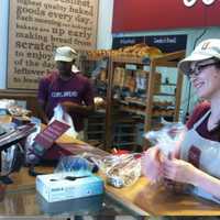 <p>COBS Bread associate Kate Donohoe helps out a customer.</p>