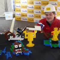 <p>Michael Tocidlowski poses with his Lego models after being crowned Master Model Builder Sunday at Ridge Hill. </p>