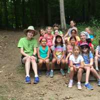 <p>Girls enjoy a temperate summer day at Camp Aspetuck on Wednesday. The counselors  Strudel and Lucky  are in their green staff T-shirts. The unit is known as Raccoon&#x27;s Rest. </p>