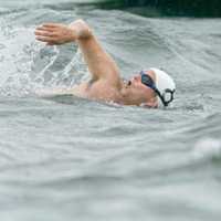 <p>A swimmer powers through the water at the Swim Across The Sound last year.</p>