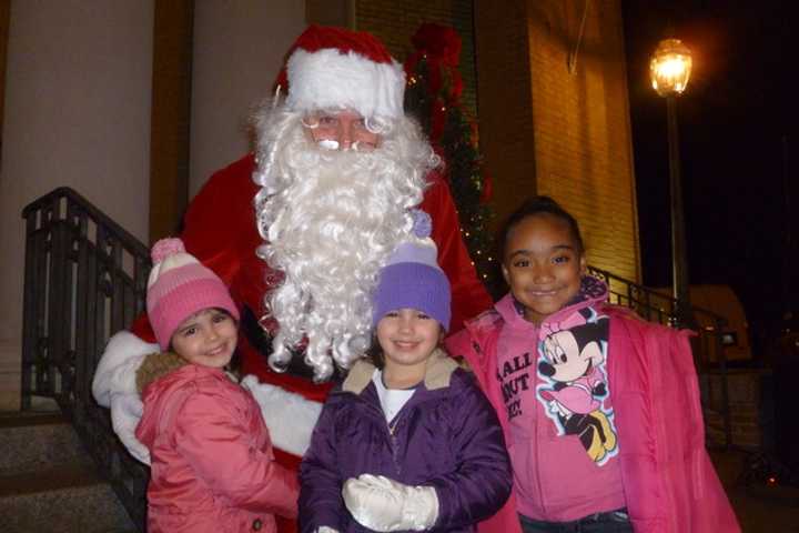 Madelyn, left, and Kaitlyn Dwyer, center, along with Jayla Odtis help welcome Santa last year at the festivities in Depot Square in Tuckahoe.
