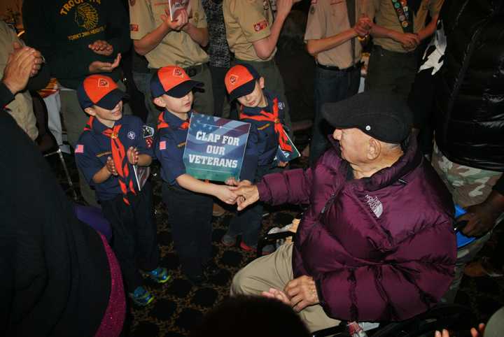 Local Scouts greet a veteran at a past Thanksgiving dinner at the Putnam County Golf Course in Mahopac.