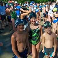 <p>Swimmers from Pleasantville (center) and other teams wait for their turn to compete.</p>