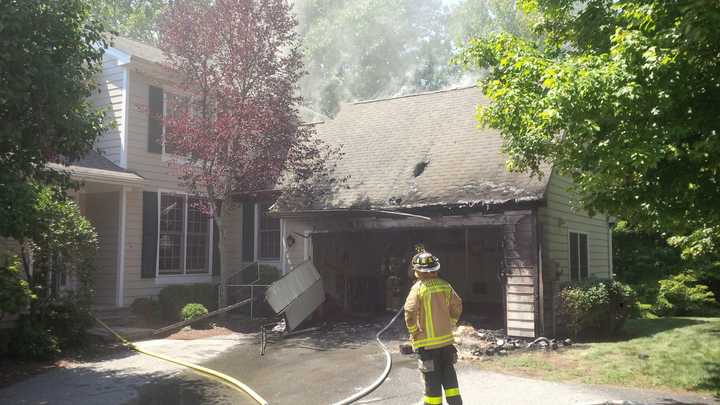 A Mount Kisco firefighter responds to a blaze at the Riverwoods condo complex in New Castle.