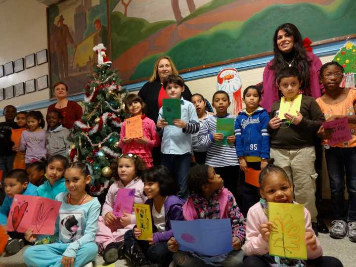 Yonkers School 23 Principal Christine Montero (right) and Asst. Principal Theresa Abate (let) joined second-grade teacher Amy Wells and her students as they made holiday cards for U.S. troops throughout the U.S. and abroad.