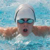 <p>Timmy Cleary, 9, of White Plains, swims in the butterfly event.</p>