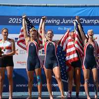 <p>Kaitlyn Kynast, partially obscured by her flag, celebrates with teammates.</p>