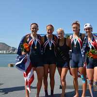 <p>Ridgefield&#x27;s Kaitlyn Kynast, right, celebrates with coach Liz Trond (center) and teammates after winning the gold medal in the Women&#x27;s 4.</p>